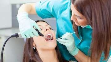 restorative dentistry spring branch | woman at dentist