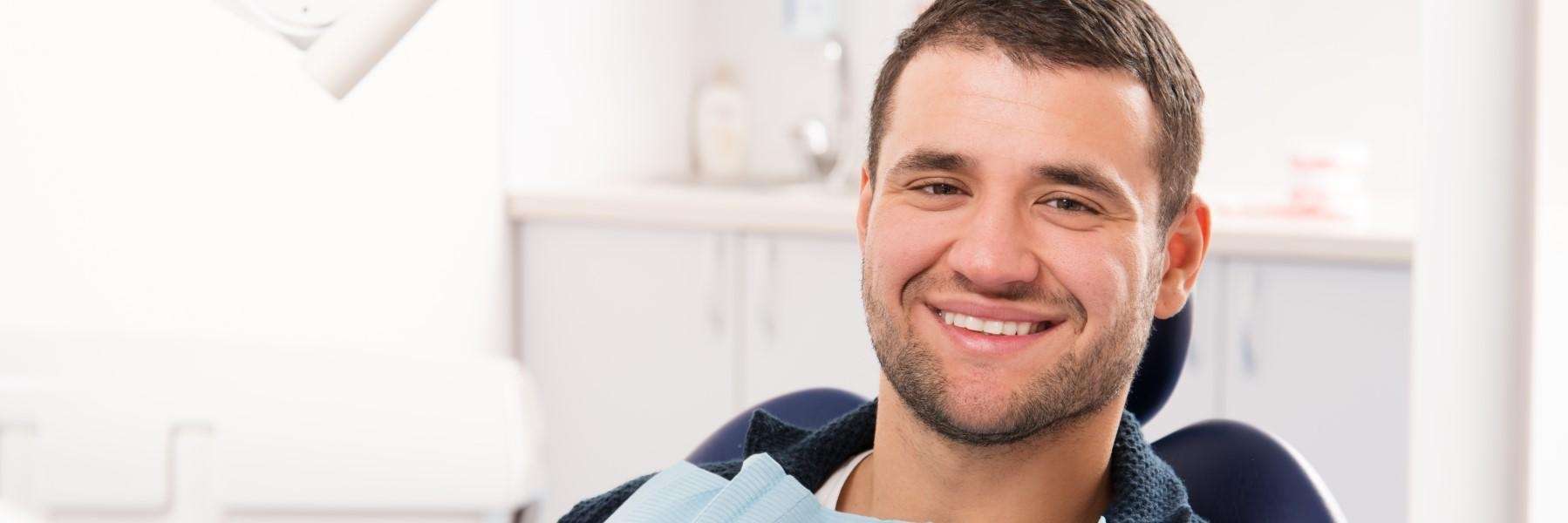 man sitting in dental exam chair | family dentist spring branch